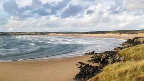 Waves enter the bay at Newborough Stock Photos