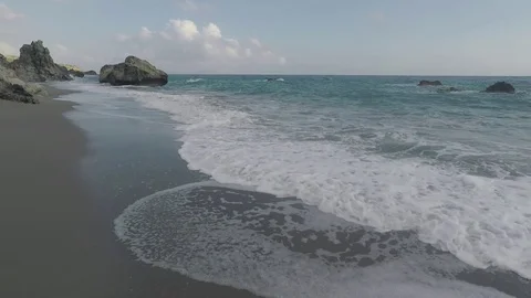 Waves in an Exotic Rocky Beach Stock Footage 75877221