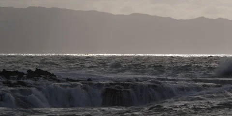 Waves exploding on a rocky reef along the Hawaiian coast Stock Footage 59525048