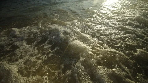 Waves floating on the sandy shore Stock Footage 212944456