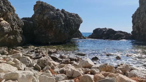 Waves flow under a huge stone Stock Footage 183822469