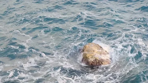 Waves flowing around small cliff rock in the sea near the coast, nature foo.. Stock Footage 228809031