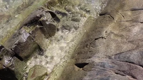 Waves flowing over stones Stock Footage 339618436