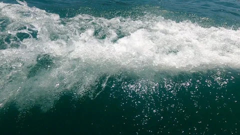 Waves, foam and spray from a speed boat on the turquoise sea Stock Footage 126829234