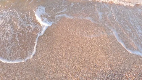 Waves with foam roll on sandy beach 스톡 동영상 165199638
