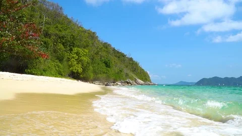 Waves with foam spread out over the sand on the beach. Thailand. Stock Footage 85569565