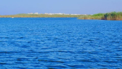 Waves generated by the land wind in a salt lake in Salento, Apulia. Italy Vídeo Stock 115362841