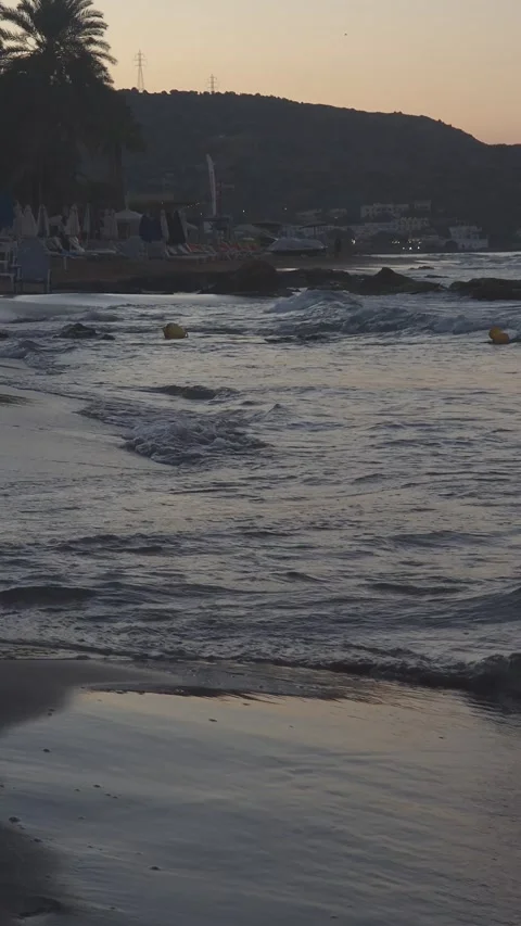 Waves Gently Crashing on a Beach at Sunset UHD 60fps Video stock 317767955