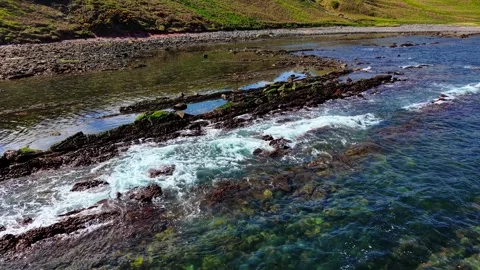 Waves gently flowing over mossy rock layers at Siccar Point on North Sea in Stock Footage 311815576