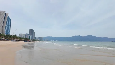 Waves Gently Hitting Da Nang Shoreline on a Calm Beach Day Stock Footage 314118308