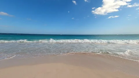 Waves gently lap the Caribbean beach Stock Footage 295900012