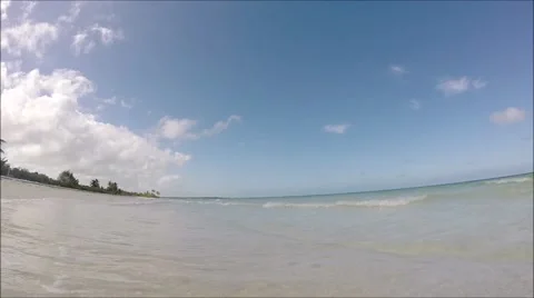 Waves gently lapping against tropical beach Stock Footage 47297093