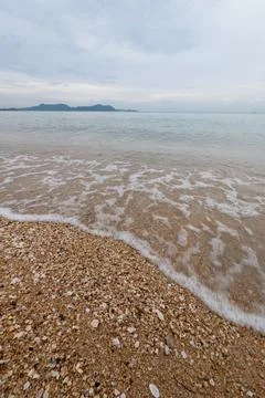 Waves gently lapping sandy beach coastal region nature serene environment w.. 写真素材
