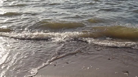 Waves gently lapping the shore along the Gulf of Finland in Estonia Stock Footage 296499478