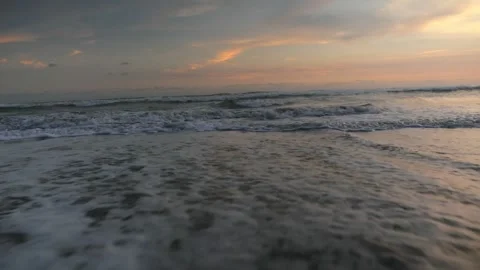 Waves gently roll sunset Stock Footage 337980945