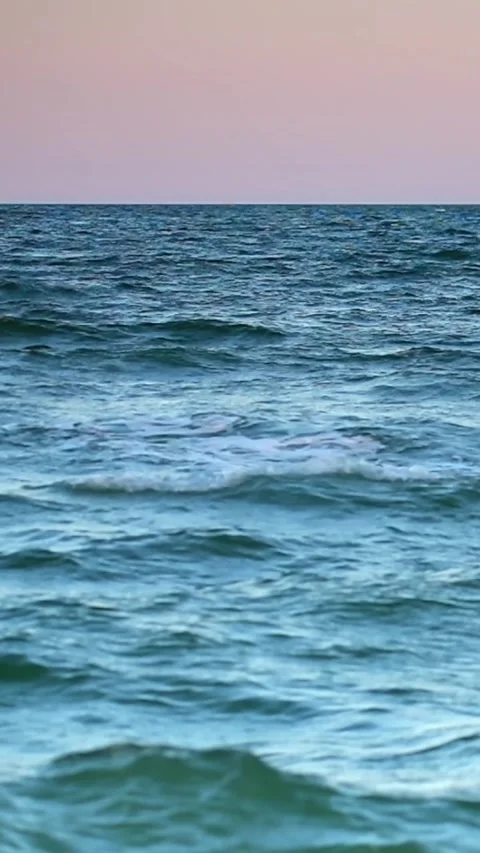 Waves gently rolling on a calm ocean surface Stock Footage 345722696