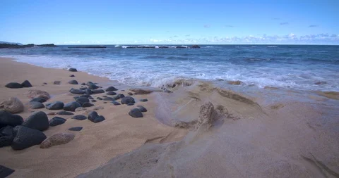 Waves Gently Rolling in Near Three Tables on the North Shore of Oahu Stock Footage 104377115