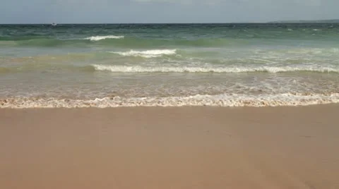 Waves gently rolling onto the sandy beach Stock-Footage 12094703