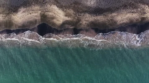 Waves gently touch the shore on a sunny day at the beach Stock Footage 335141586