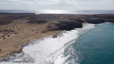 Waves gently touch the shores of Del Pozo Beach in Lanzarote, Canary Islands Video stock 303617600