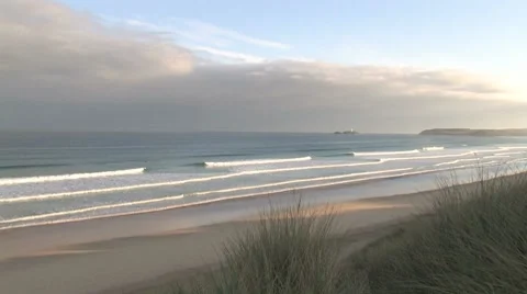 Waves gently wash up onto beach Stock Footage 8623577