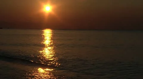 Waves gently wash up onto beach at sunset (High Definition) Stock Footage 11528304