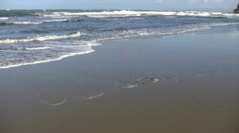 Waves gently wash up onto beach, then recede (High Definition) Stock-Footage 65572