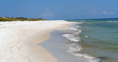 Waves gently wash up on white sandy beach, dunes, gulf and shoreline background Stock Footage 98931330