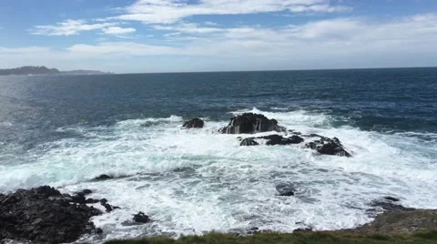 Waves going over rock in pacific ocean california pebble beach hole 7 Stock Footage 61863766