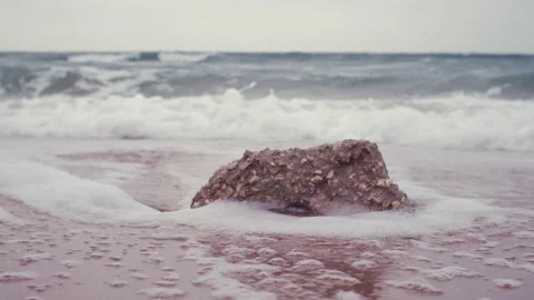 Waves hide the stone with foam Stock Footage 159500463