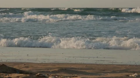 Waves hit the beach in sunset time Stock Footage 157270654