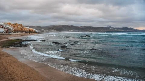 Waves hit breakwater Stock Photos