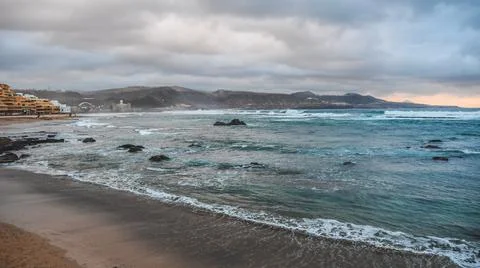Waves hit breakwater Stock Photos