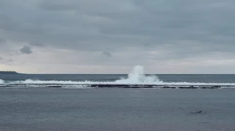 Waves hit breakwater Stock Photos