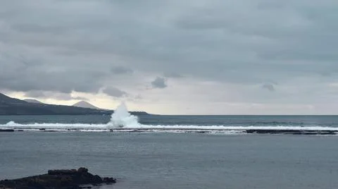Waves hit breakwater Stock Photos