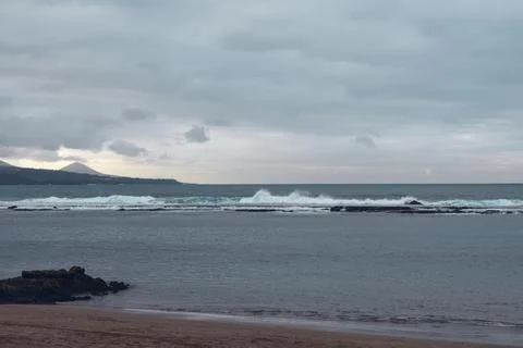 Waves hit breakwater Stock Photos