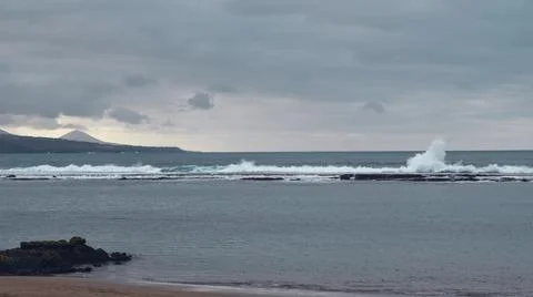 Waves hit breakwater Stock Photos