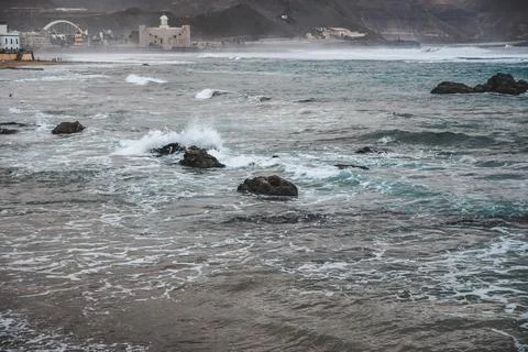 Waves hit breakwater Stock Photos
