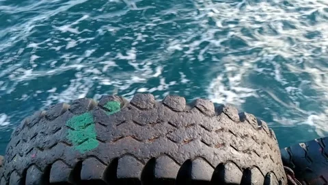 The waves hit the dapra tires Stock Footage 277199146