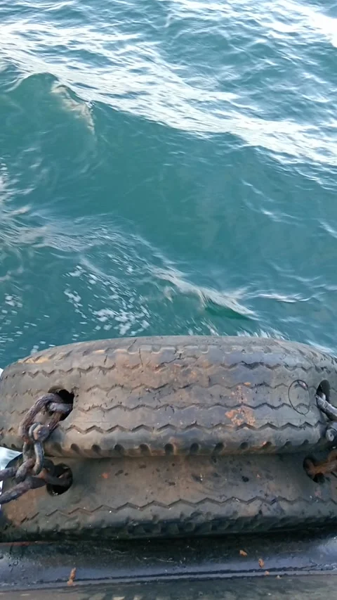 The waves hit the dapra tires Stock Footage 277199156