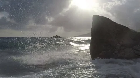 Waves hit a rock in the Beach - Slow Motion Stock Footage 75942620