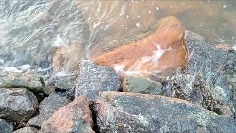 The waves hit the rocks on the beach Stock Footage 278445537