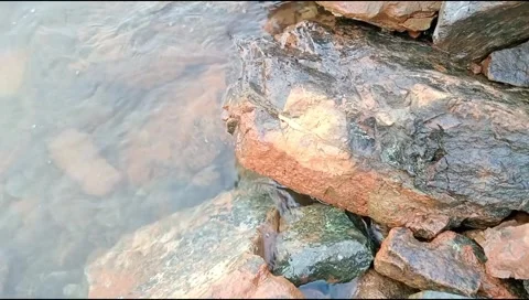 The waves hit the rocks on the beach Stock Footage 278446656
