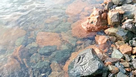 The waves hit the rocks on the beach Video stock 278447480