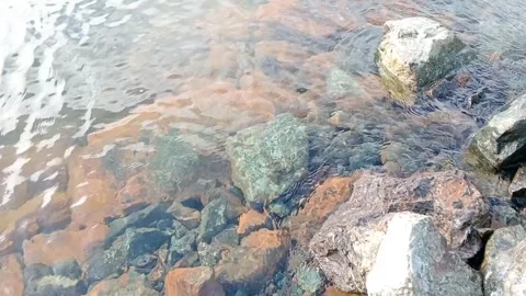 The waves hit the rocks on the beach Stock Footage 278447808