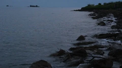 The waves hit the rocks on Mamuju beach in the morning Stock Footage 237905919