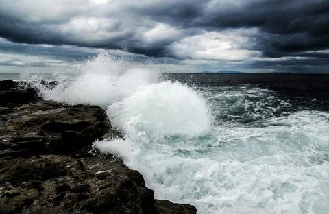 The waves hit the rocks, with several different views, symbolizing the never- Stock Photos