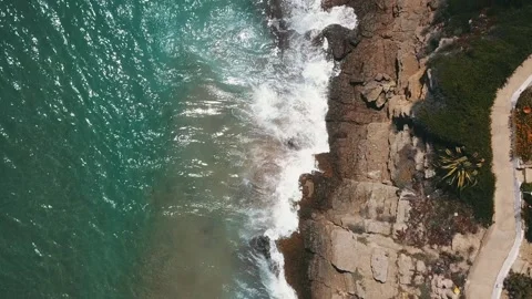 Waves hit rocky coast Stock Footage 147057393