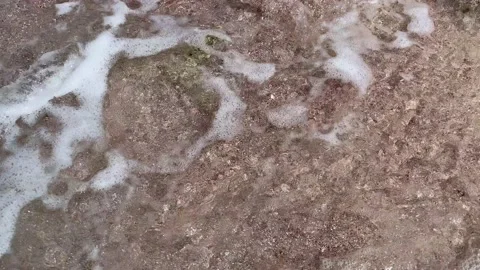 Waves hit the sandy beach and slowly fades away, soft waves moving in and out. Stock Footage 168356227