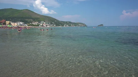 Waves hit the shore of the beach in Liguria in Italy - 4K, Handheld, Editorial Stock Footage 157287611